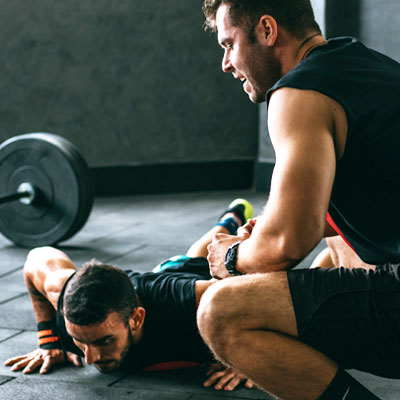A Man Exercising with his Personal Trainer