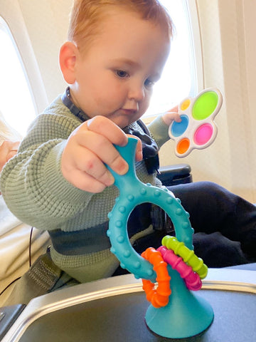 Baby playing with FatBrain toys - PipSquigz Loops and a Dimpl.