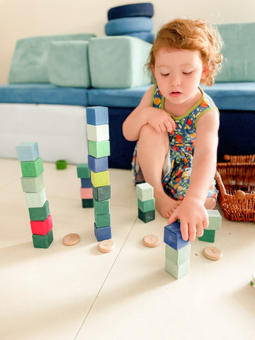 Child making block towers.