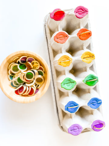 Colour-matching with metal-rimmed counting chips and a painted egg carton.