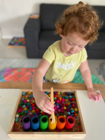 Colour matching pompoms with the Lola tubes.