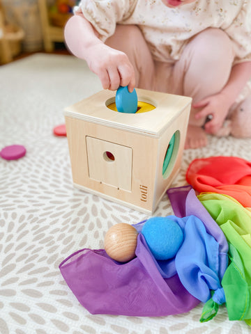 Little girl playing with a montessori style totli box