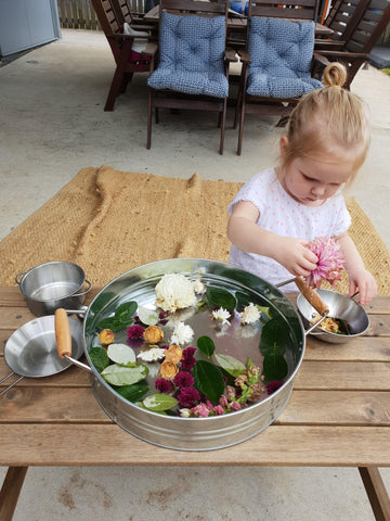 Nature-based sensory play with a toddler.