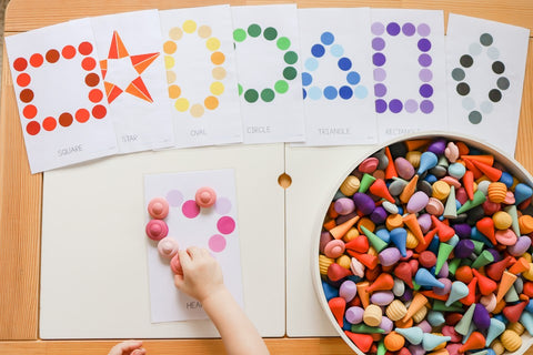 Child making shapes with Grapat mandala pieces