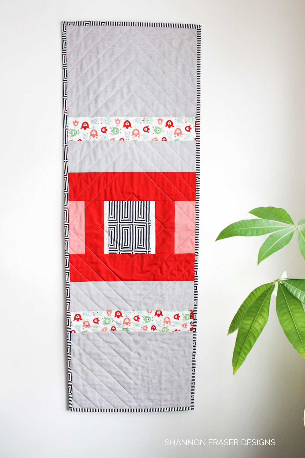 Modern improv quilted backing using red, coral, essex linen, black and white print on the back of the Modern Aztec quilted table runner | Christmas table linen | Shannon Fraser Designs #tablerunner