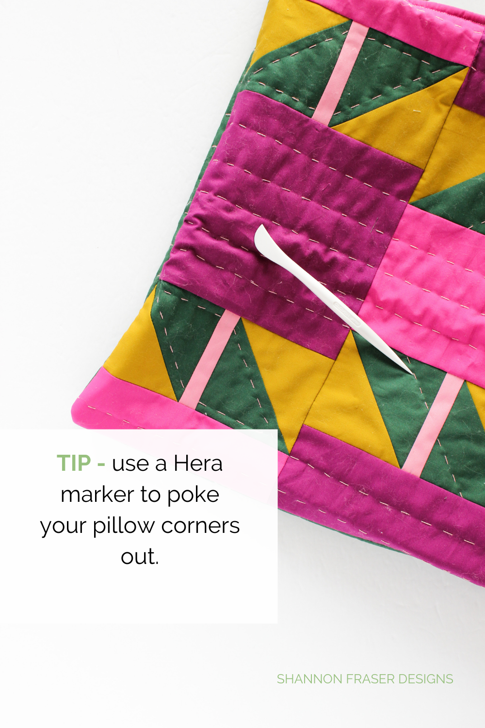 TIp: use a Slim Hera Marker to gently poke out the corners of your Shattered Star quilted lumbar pillow for nice points | Sewing Tutorial: How to insert a metal zipper | Shannon Fraser Designs #diycushion