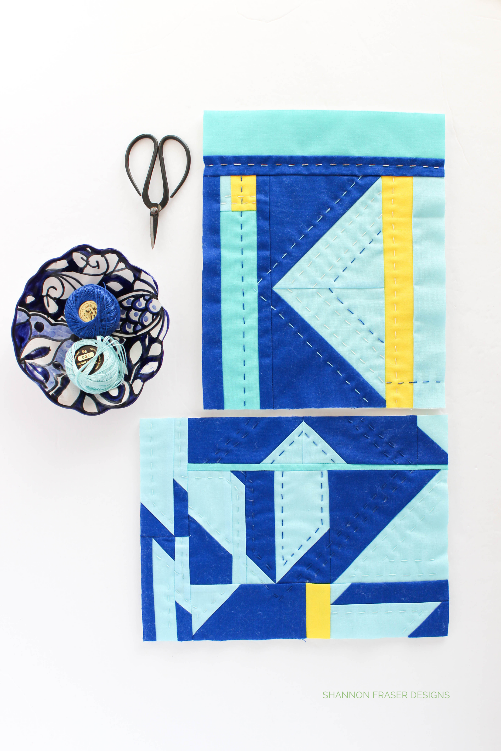 Blue and yellow modern mini abstract improv quilts featuring fabric scraps and hand quilted with pearl cotton thread | Shannon Fraser Designs #sustainablequilting #noscapwasted #fiberart #miniquilt