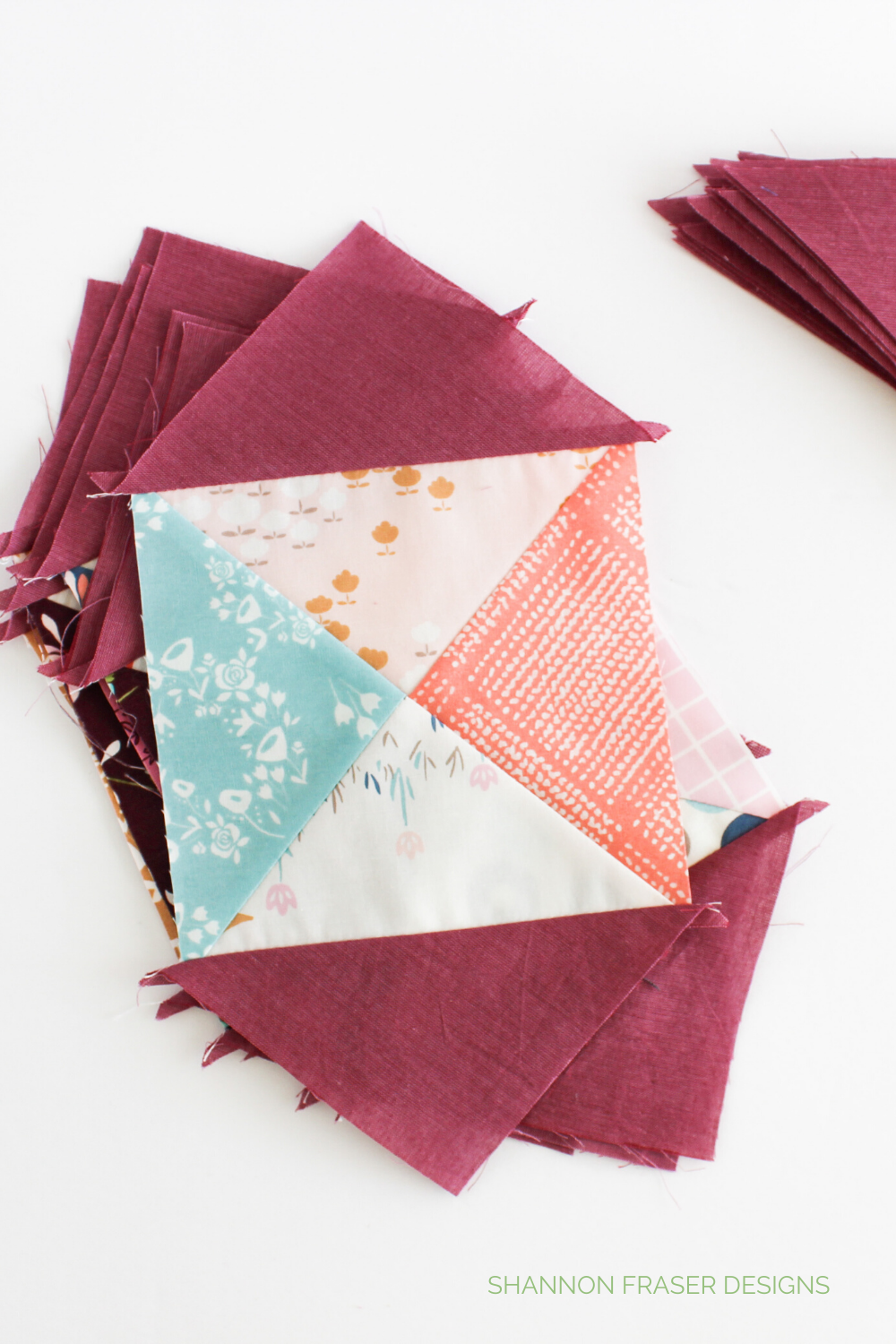 Hourglass blocks with raspberry shot cotton triangles attached to two opposite sides | Spring Lilacs quilt | Shannon Fraser Designs #hourglassblock