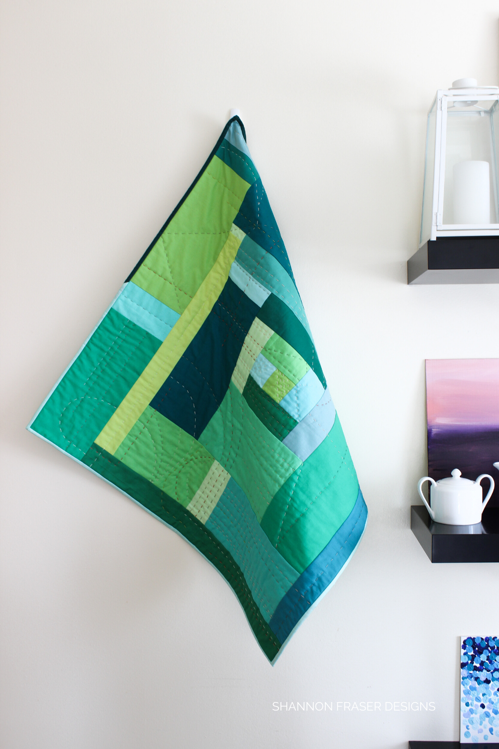 Green "F" Quilt hanging next to black shelves | Exploring emotion through improv quilting | Shannon Fraser Designs