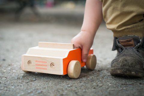 wooden toys pushing along the ground free outdoor open ended play