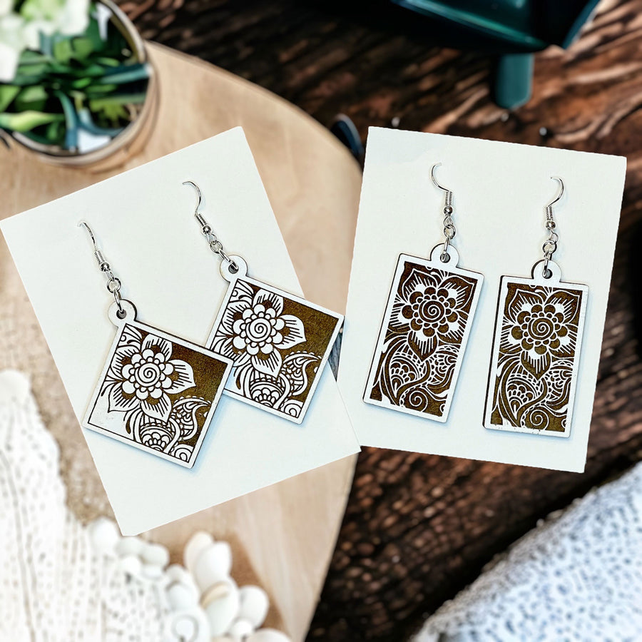 https://cdn.shopify.com/s/files/1/0017/2231/8946/files/FloralMandalaRectangleDangleEarrings-2square_900x.jpg?v=1686645726