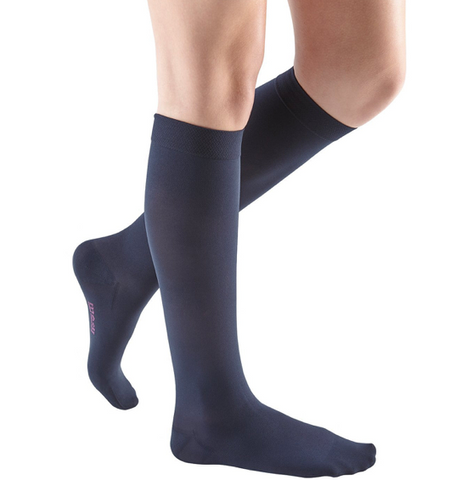 person wearing navy knee high compression socks