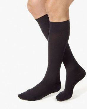 person wearing black knee high compression socks