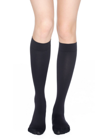 person wearing navy knee high compression socks