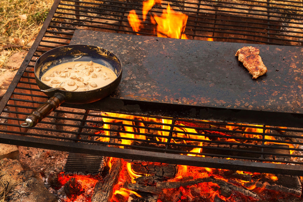 cooking with cast iron skillet over campfire