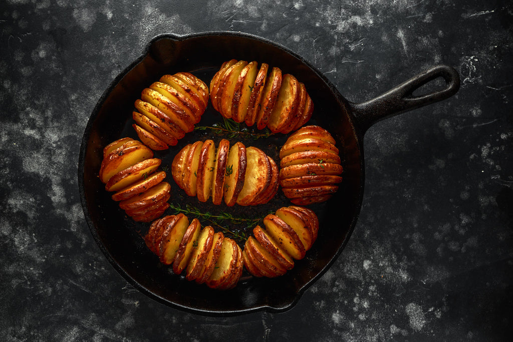 hasselback potatoes baked in a cast iron skillet