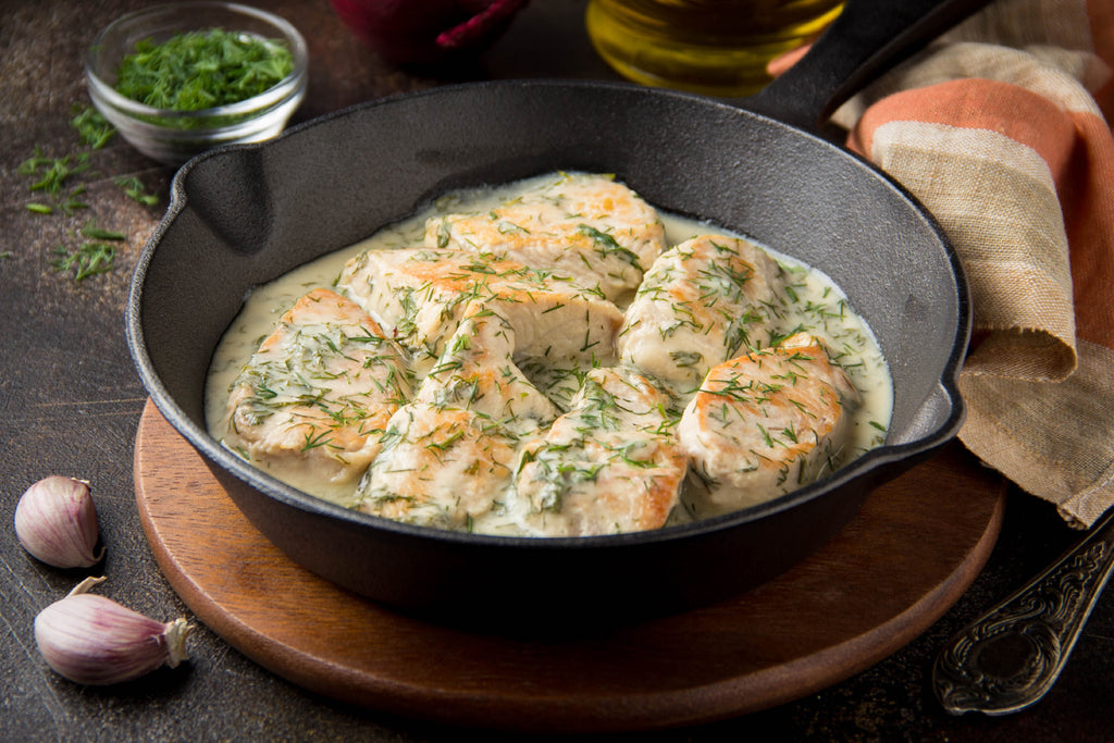 fish casserole in a cast iron skillet made on induction stovetop