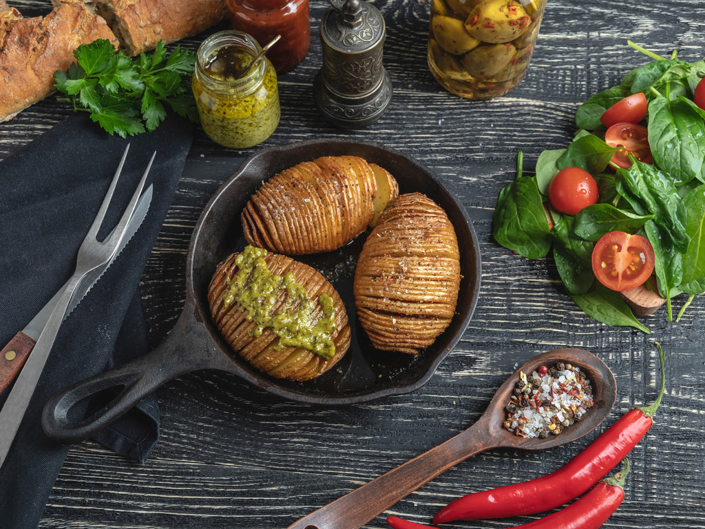 praparing hasselback potatoes that will be baked and served in a cast iron skillet