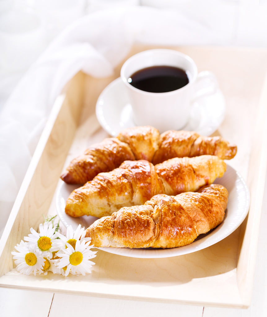 Croissants served with a coffee and flowers