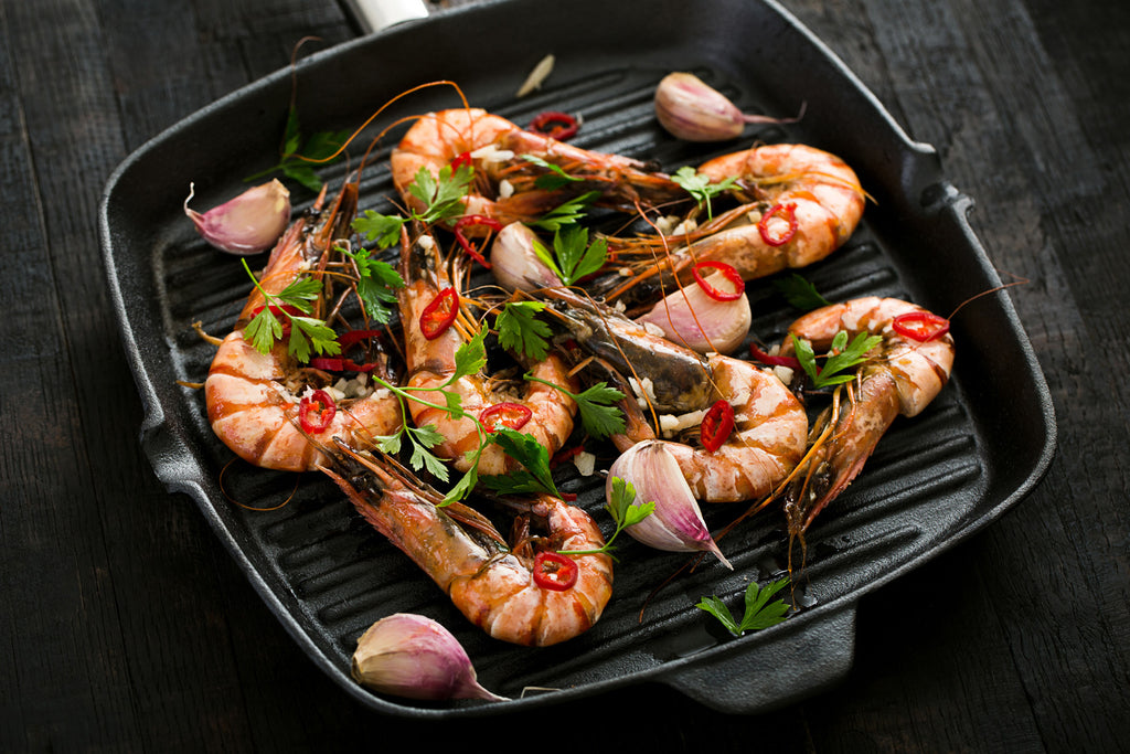 cooking shrimps in a cast iron grill pan