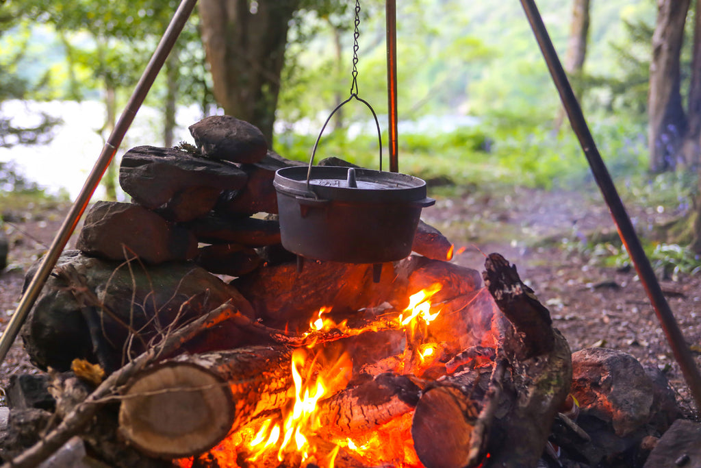 cast iron camp <tc>dutch oven</tc> davanti al fuoco