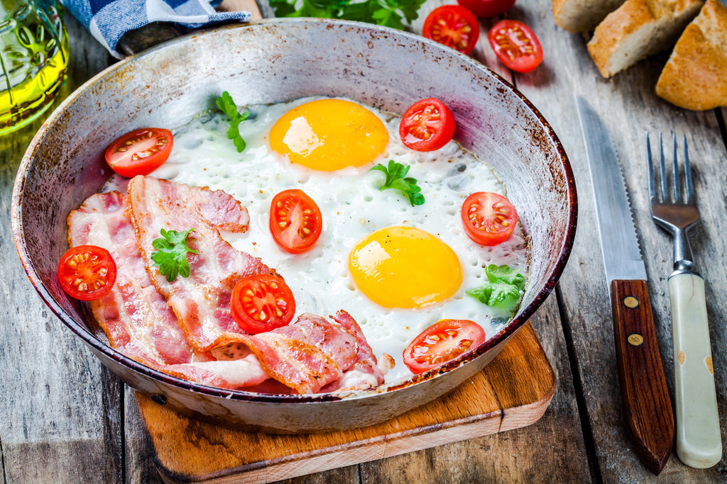 bacon with eggs in a carbon steel pan