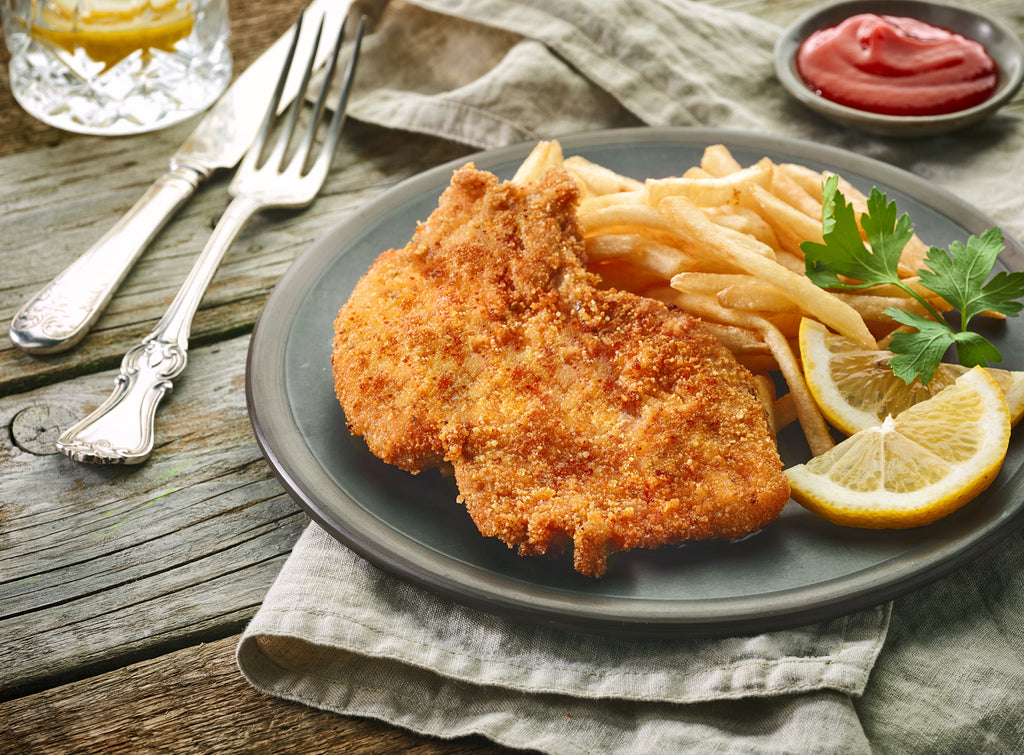 Wienerschnitzel served with fires and lemon