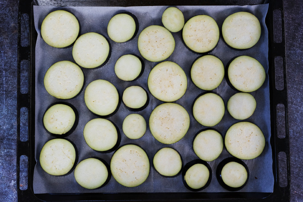 sliced eggplant on a baking tray