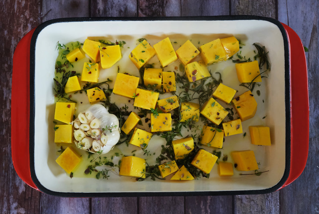 cubed butternut squash in an enameled cast iron roasting pan