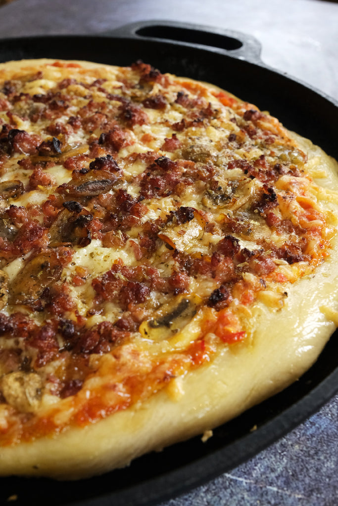 pizza in a cast iron pizza pan