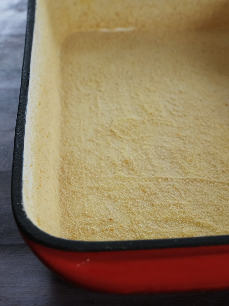 enameled cast iron roasting pan buttered with bread crumbs