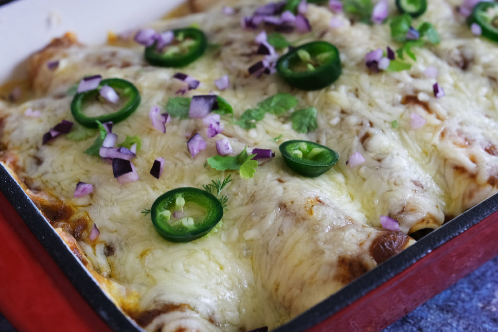 enchiladas topped with Jalapeño and red onion