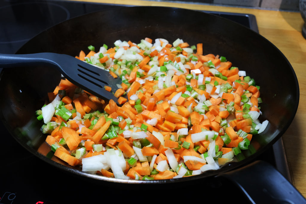 sweating vegetables in a carbon steel pan