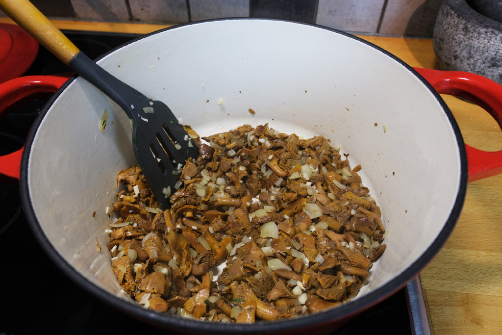 chanterelle and onion in an enameled cast iron dutch oven