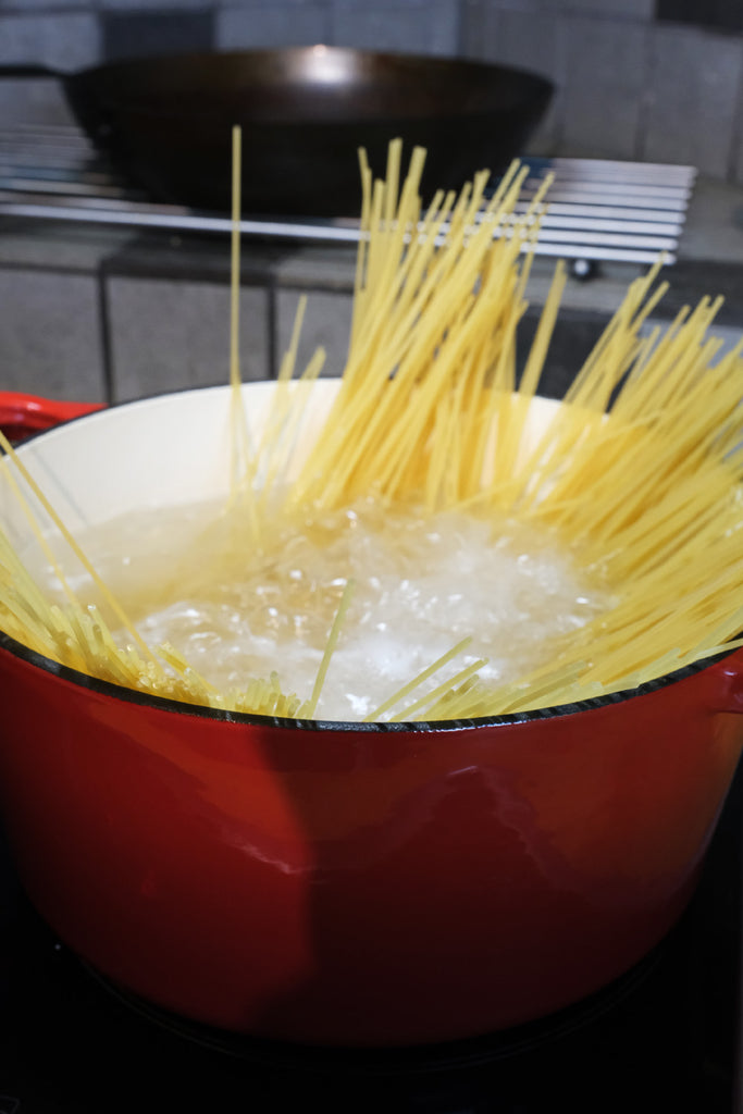 pasta boiling in an enameled cast iron Dutch oven