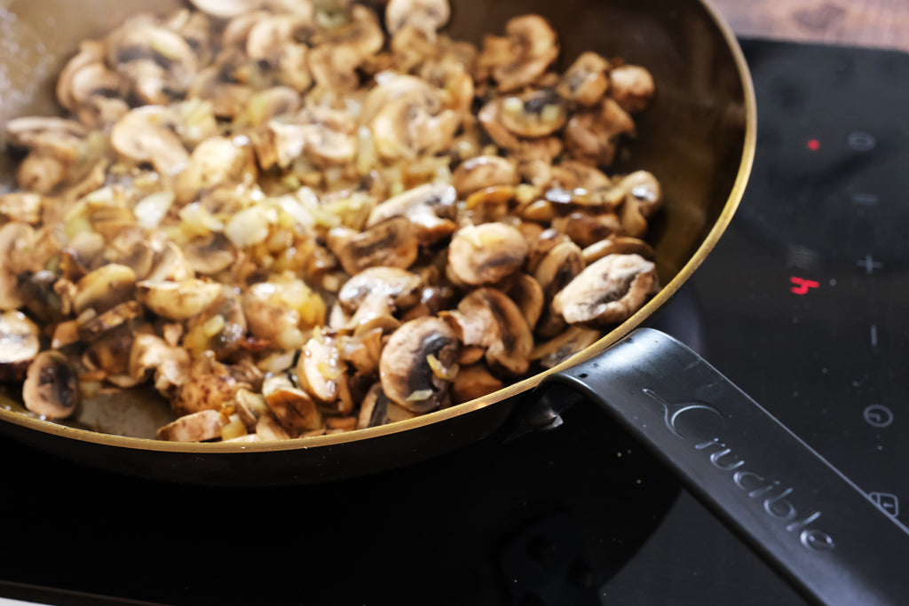 mushrooms in a carbon steel skillet frying pan