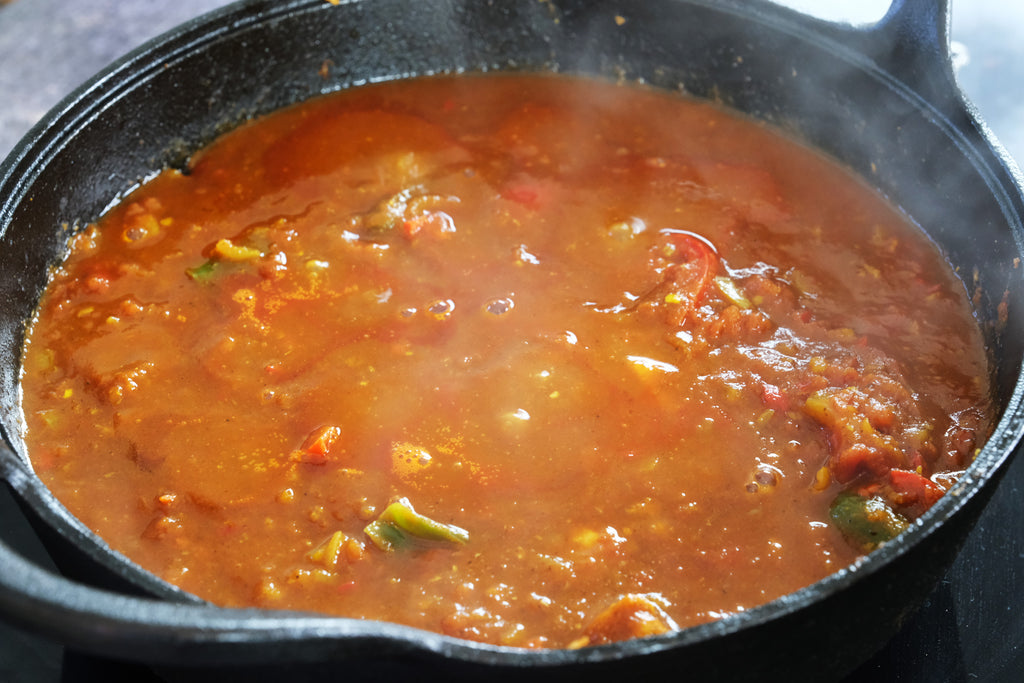 balti curry chicken in a cast iron balti dish