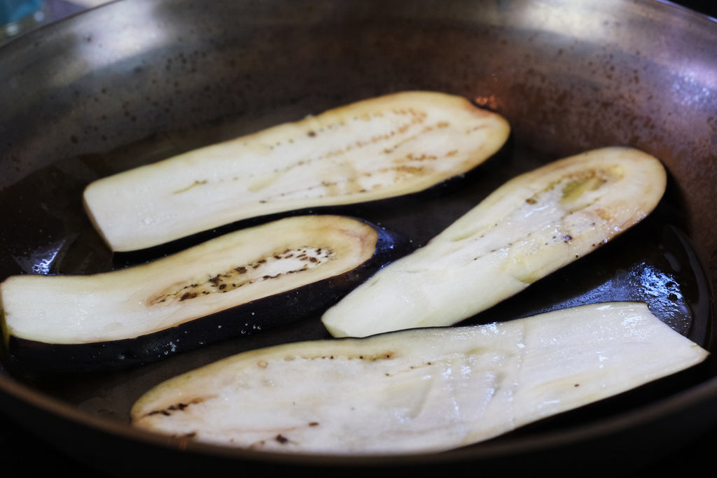 eggplant slices in a frying pan