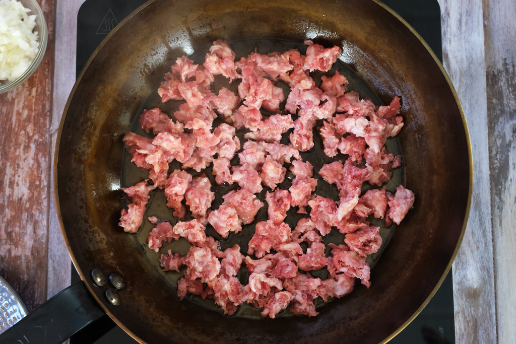 salsiccia in a carbon steel pan