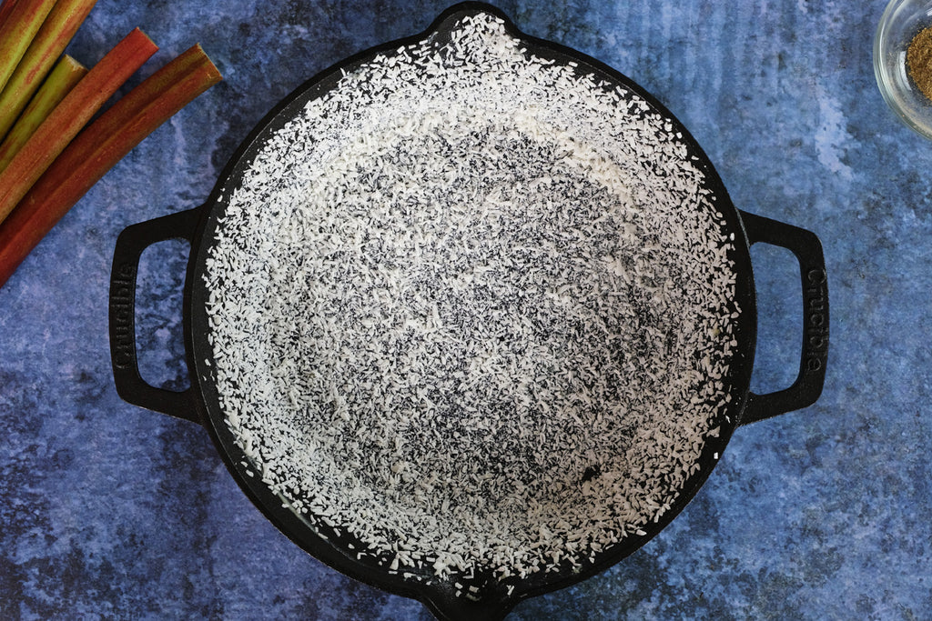 coconut flakes in a cast iron skillet