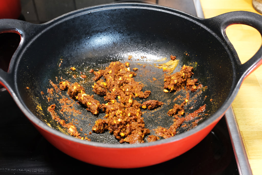 spices in an enameled cast iron balti dish casserole cookware