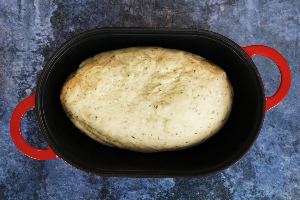 dough in a cast iron bread pan