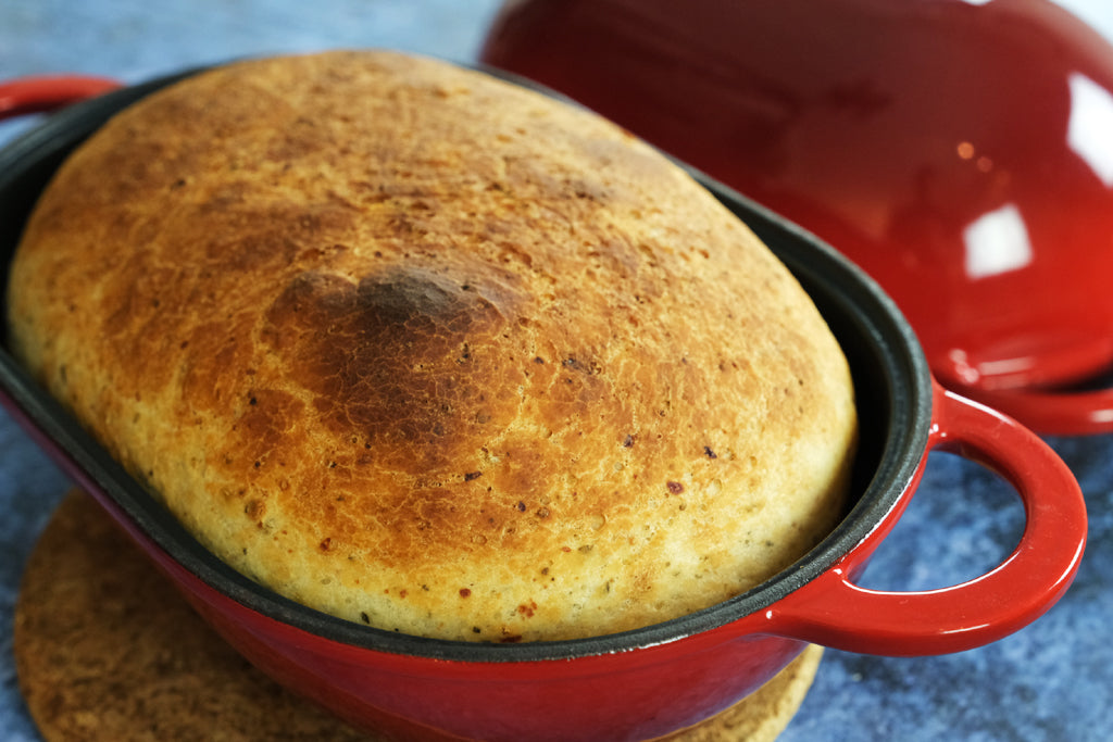italian herb bread in an enameled cast iron bread pan