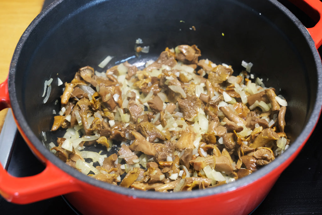 chanterelle and oinon in an enameled dutch oven