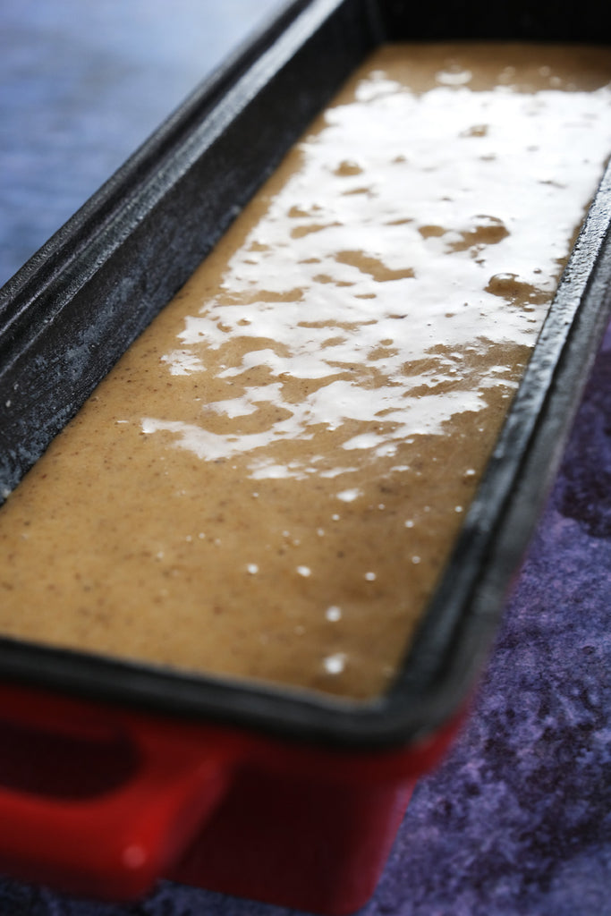 spice cake batter in an enameled cast iron bread pan