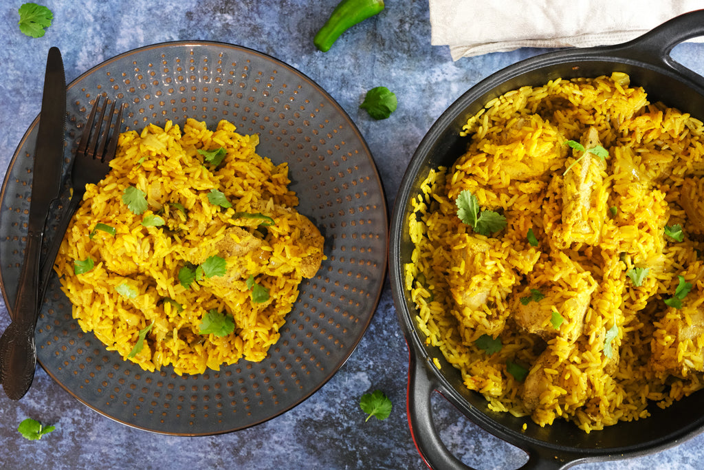biryani served topped with fresh coriander cooked with an enameled cast iron balti dish