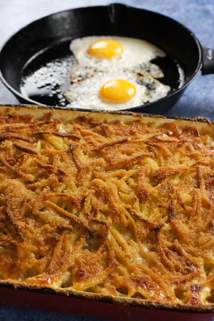 janssons frestelse with fried eggs in a cast iron skillet