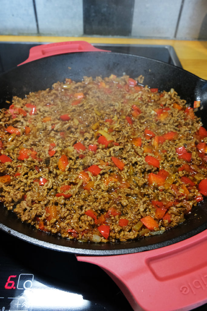 taco pie filling prepared in a 12" cast iron skillet