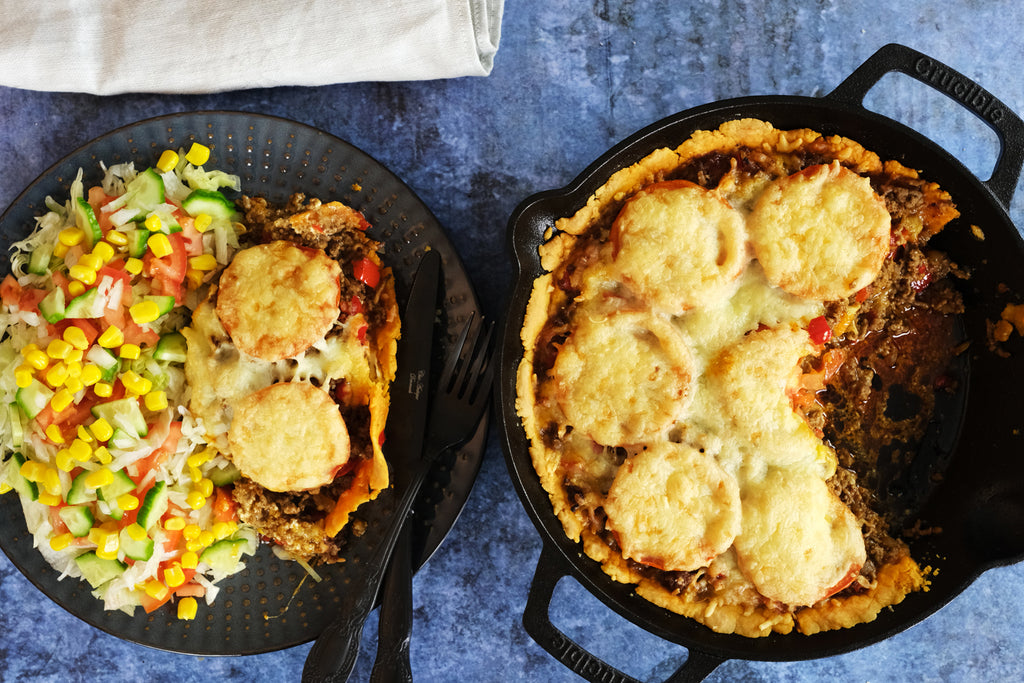 taco pie baked in a 10.25" inch cast iron skillet served with a salad