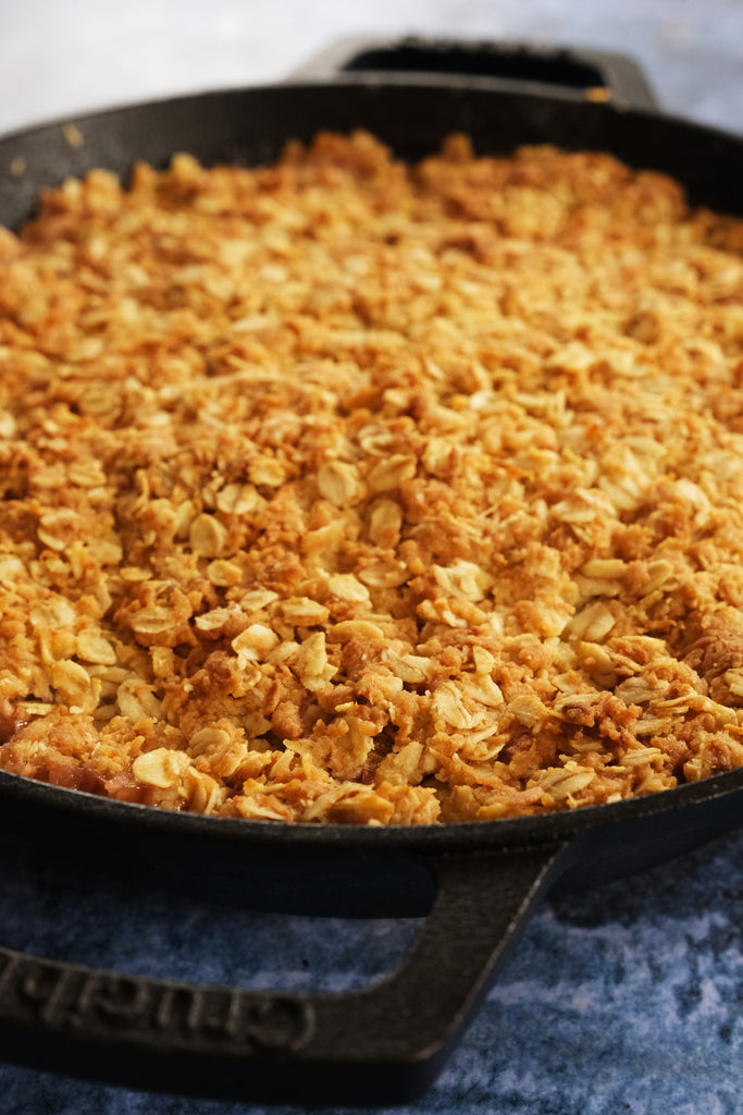 rhubarb pie with oat and coconut crust in a cast iron skillet with loop handles